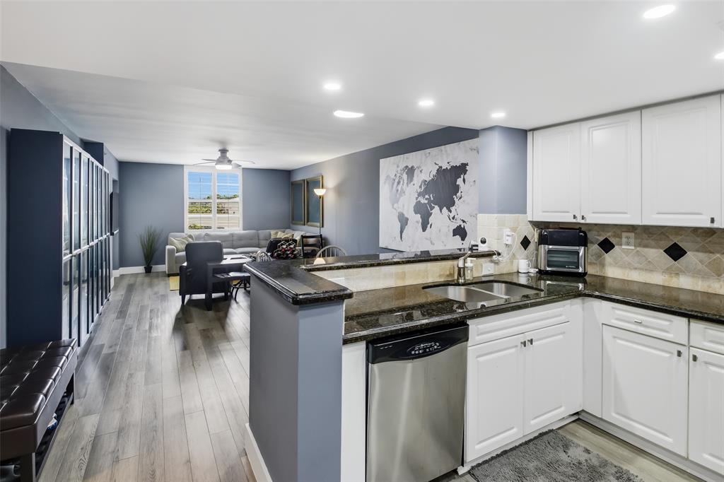 520 Southeast 5th Avenue, Unit 3208 Fort Lauderdale, FL 33301 - Photo 11 of 71 a kitchen with stainless steel appliances granite countertop a stove top oven a sink dishwasher and cabinets with wooden floor