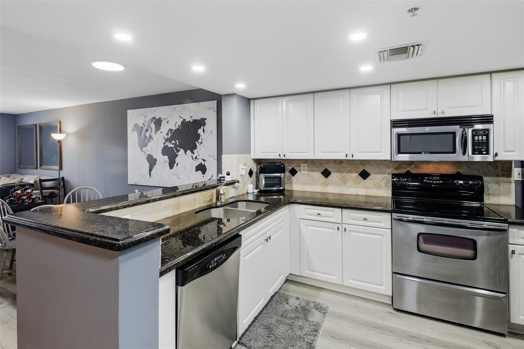 520 Southeast 5th Avenue, Unit 3208 Fort Lauderdale, FL 33301 - Photo 17 of 71 a kitchen with granite countertop a stove top oven sink and cabinets