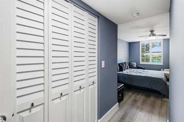 a front view of building with outdoor space water fountain and tall trees