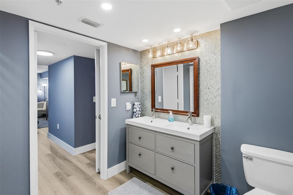 520 Southeast 5th Avenue, Unit 3208 Fort Lauderdale, FL 33301 - Photo 42 of 71 a bathroom with a double vanity sink a toilet and mirror