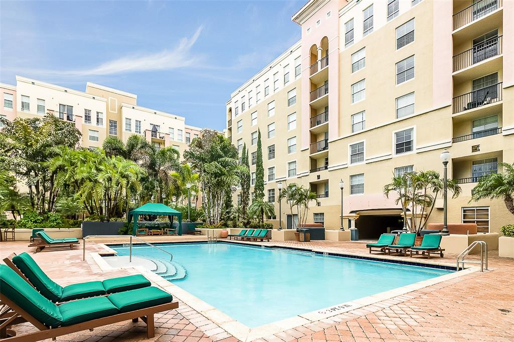 520 Southeast 5th Avenue, Unit 3208 Fort Lauderdale, FL 33301 - Photo 52 of 71 a view of a swimming pool with a lounge chairs
