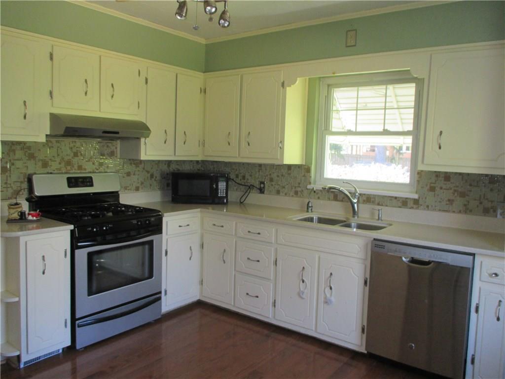 1900 Tuscarawas Road Beaver, PA 15009 - Photo 7 of 25 Kitchen with Corian countertops and glass backsplash.