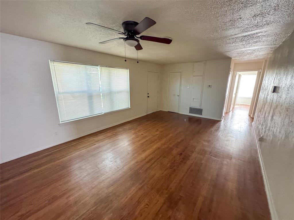 60 Pershing Drive, Unit A Denison, TX 75020 - Photo 2 of 11 a view of empty room with wooden floor and fan