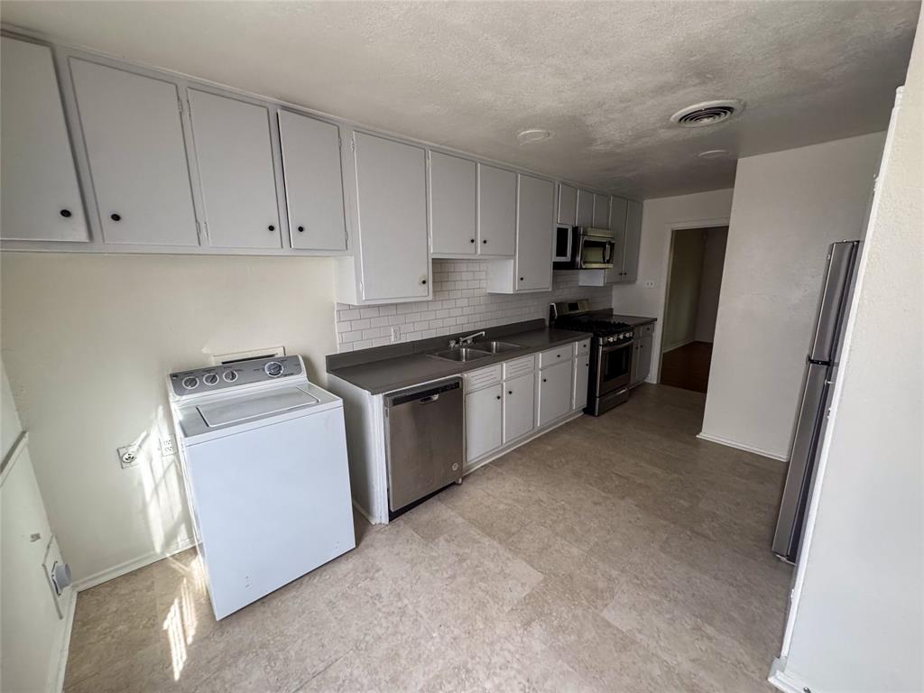 60 Pershing Drive, Unit A Denison, TX 75020 - Photo 6 of 11 a kitchen with a sink a stove and refrigerator
