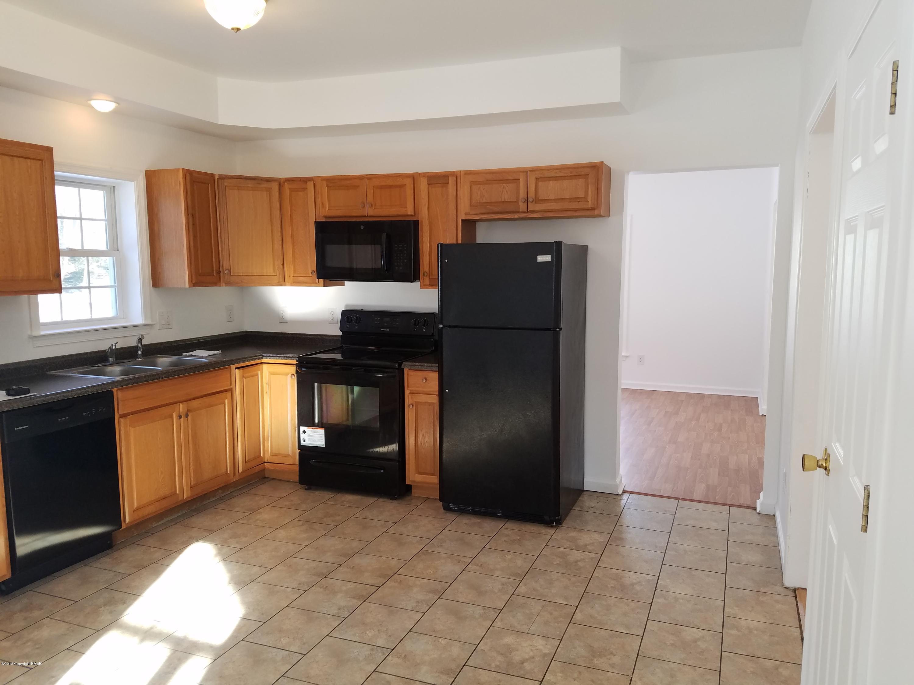 2302 Winchester Road Pocono Summit, PA 18346 - Photo 4 of 25 a kitchen with stainless steel appliances granite countertop a refrigerator and a sink