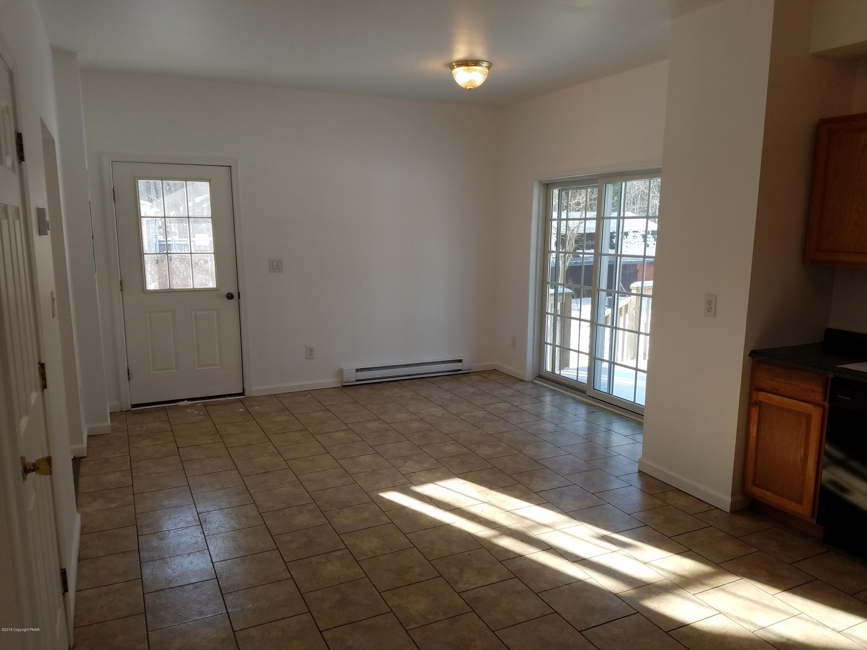 2302 Winchester Road Pocono Summit, PA 18346 - Photo 5 of 25 an empty room with windows
