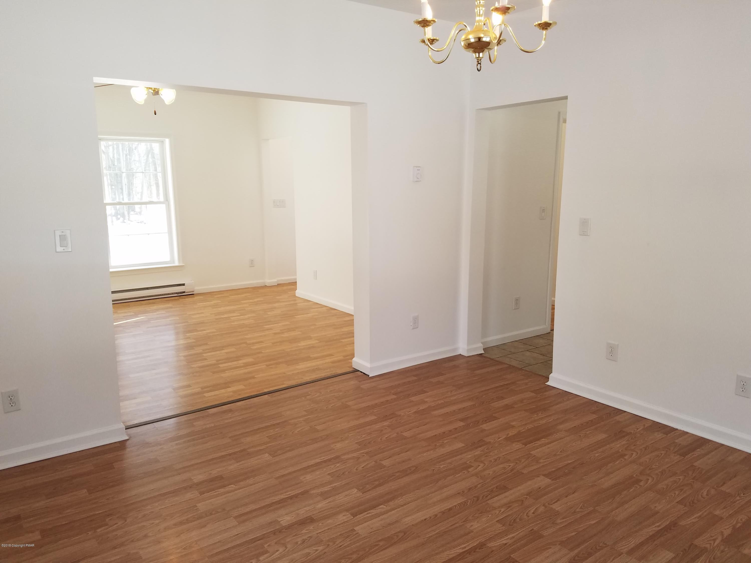 2302 Winchester Road Pocono Summit, PA 18346 - Photo 8 of 25 a view of an empty room with wooden floor