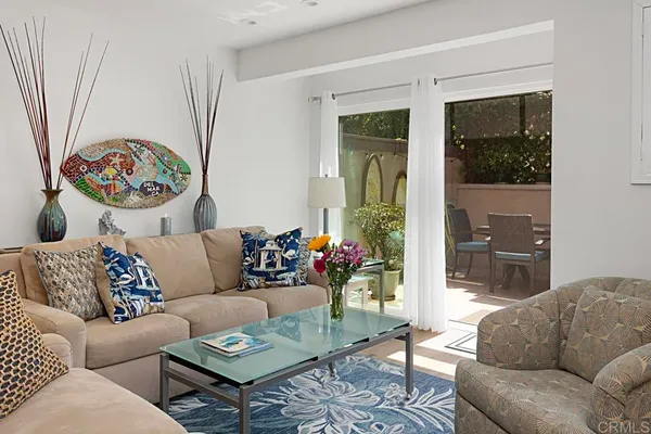 a living room with furniture and a potted plant