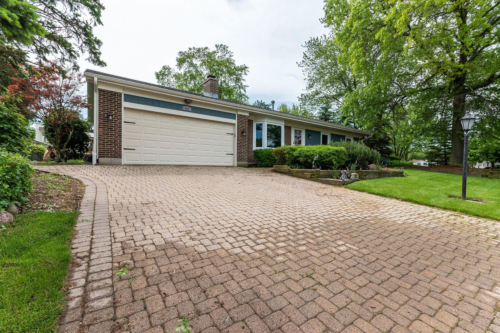 993 Pheasant Ridge Drive Lake Zurich, IL 60047 - Photo 2 of 25 a front view of a house with a yard and garage