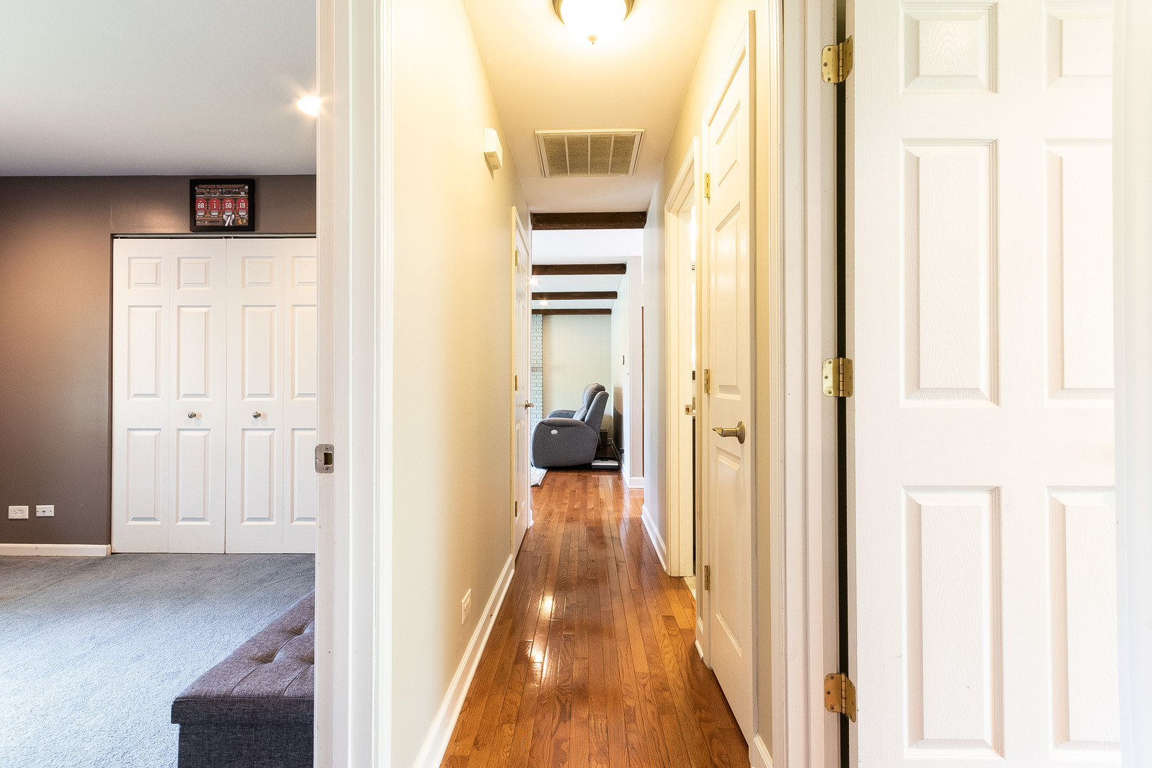 993 Pheasant Ridge Drive Lake Zurich, IL 60047 - Photo 20 of 25 a view of a hallway with wooden floor and living room