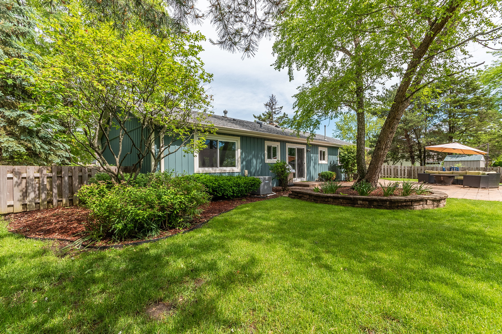 993 Pheasant Ridge Drive Lake Zurich, IL 60047 - Photo 23 of 25 a view of a house with backyard sitting area and garden