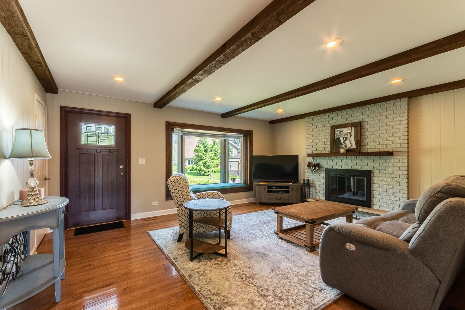 993 Pheasant Ridge Drive Lake Zurich, IL 60047 - Photo 8 of 25 a living room with furniture a fireplace and a flat screen tv