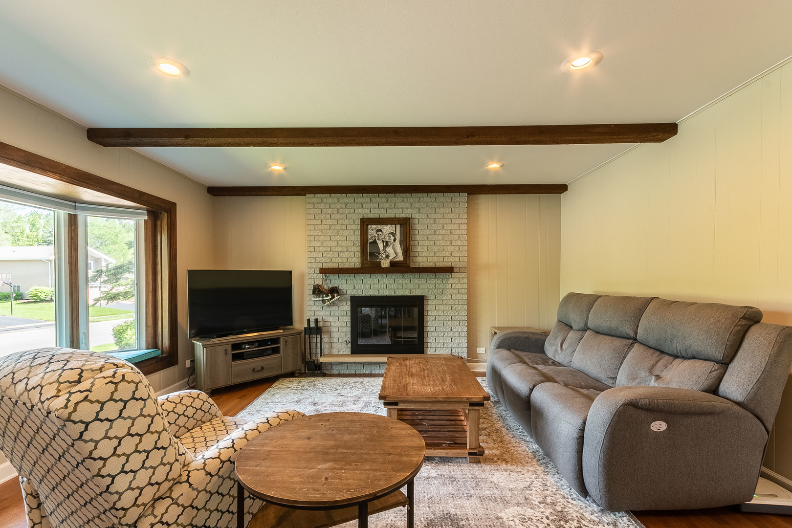 993 Pheasant Ridge Drive Lake Zurich, IL 60047 - Photo 9 of 25 a living room with furniture a fireplace and a flat screen tv