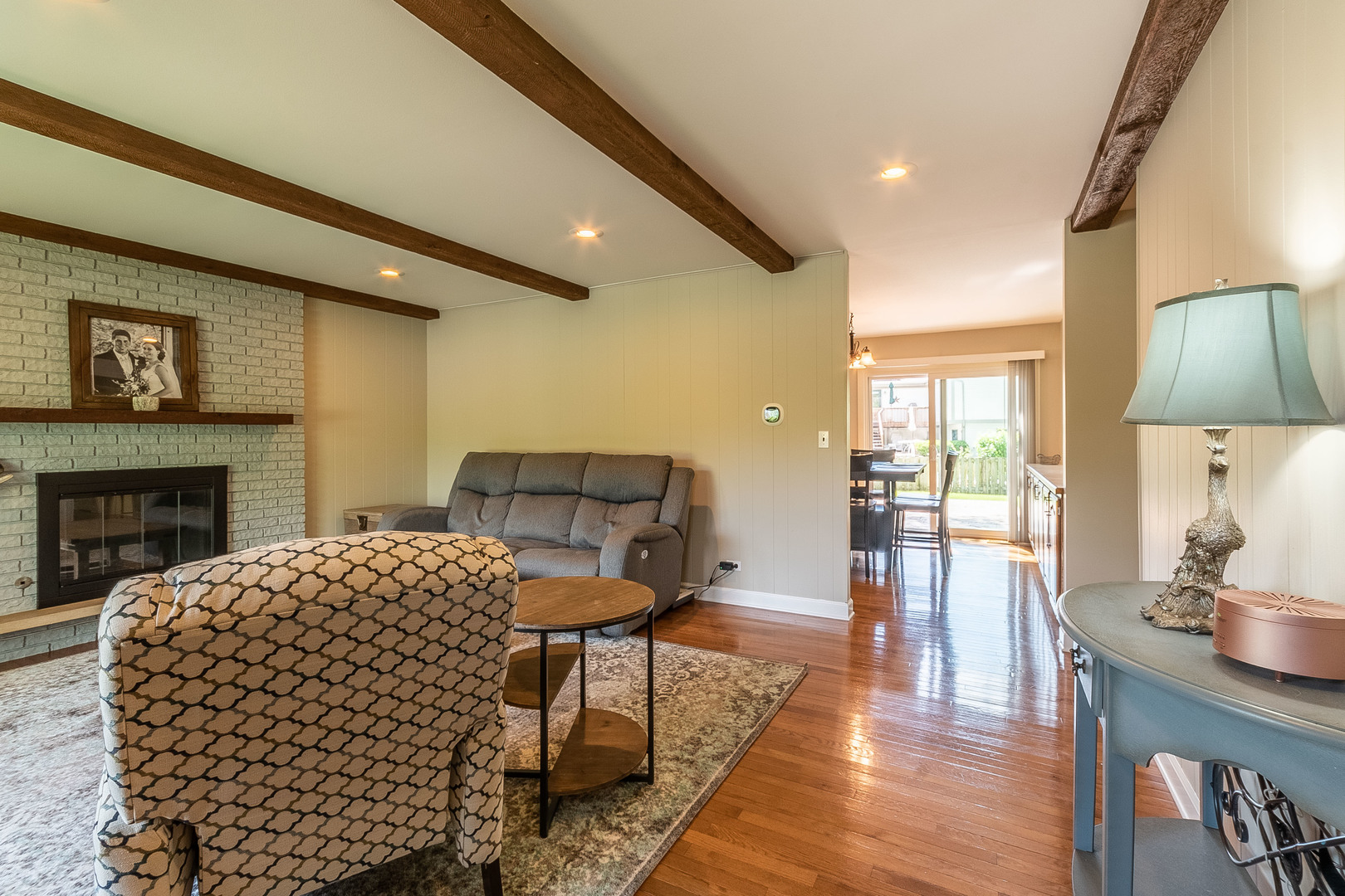 993 Pheasant Ridge Drive Lake Zurich, IL 60047 - Photo 10 of 25 a living room with furniture a large window and a fireplace