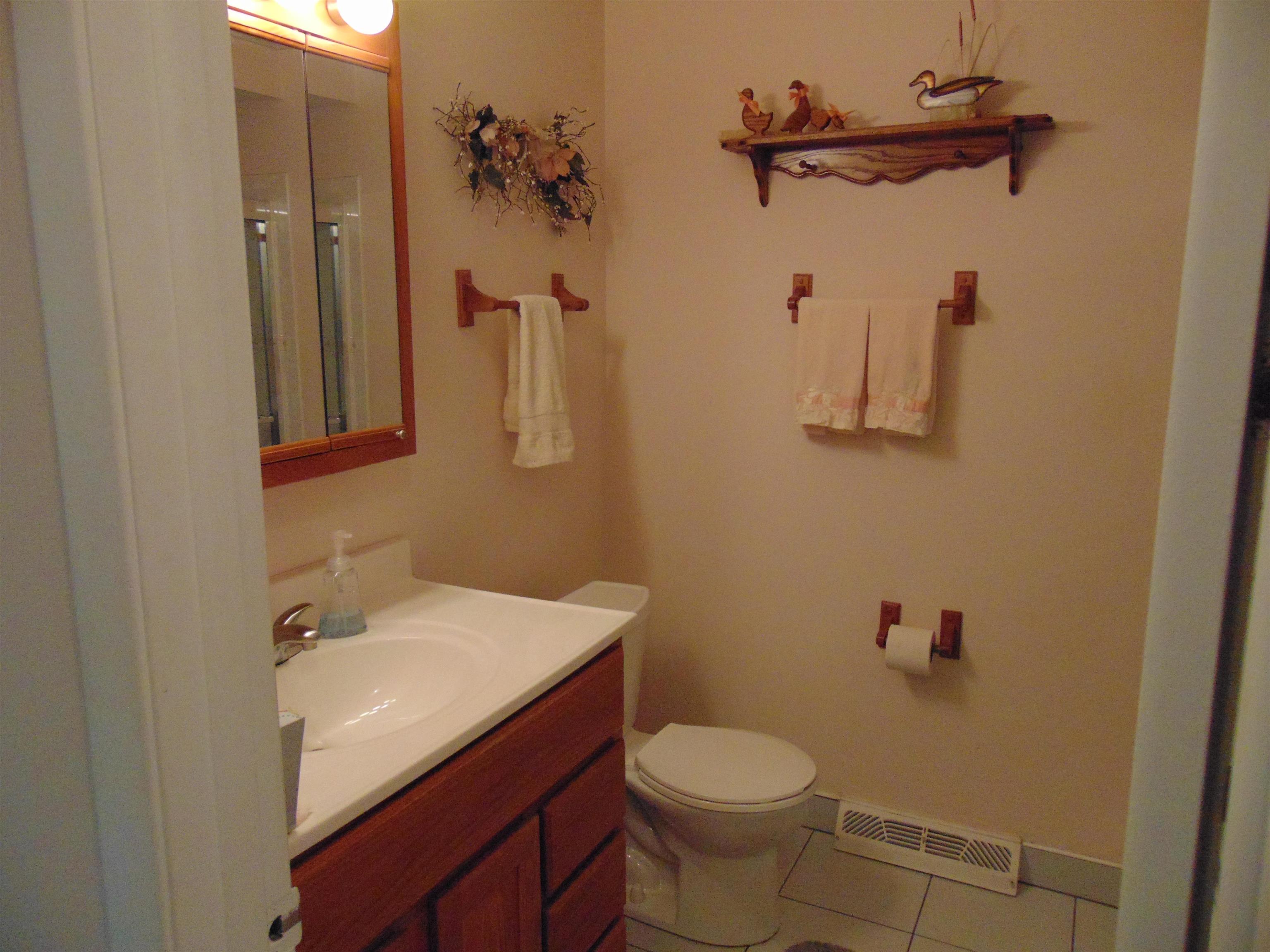 645 Sable Avenue Addison, IL 60101 - Photo 10 of 33 a bathroom with a granite countertop sink toilet and a mirror