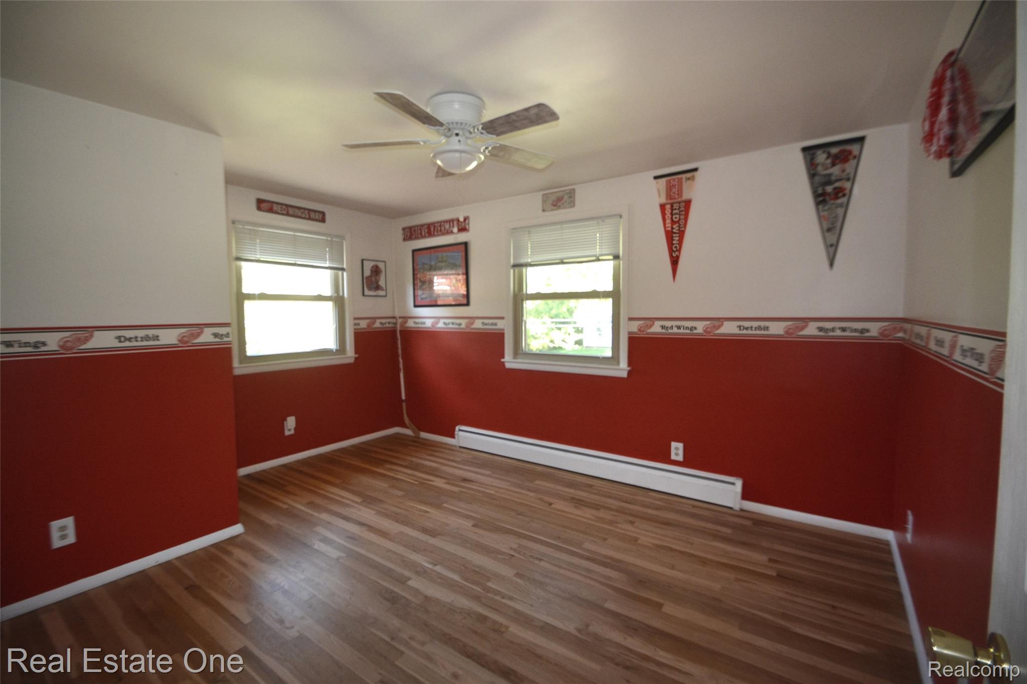 615 Willard Avenue Rochester, MI 48307 - Photo 22 of 30 Room featuring wood-finish flooring, two windows with blinds, and a ceiling fan