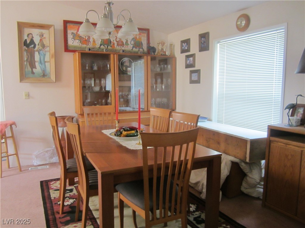 1314 Fire Station Road Ely, NV 89301 - Photo 19 of 35 Dining room featuring carpet floors and a chandeli