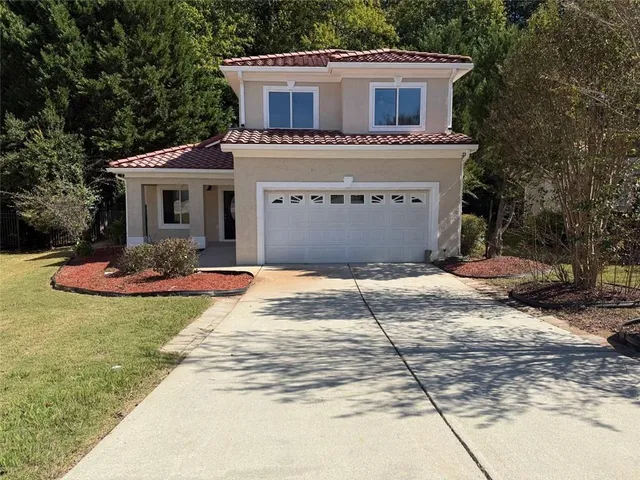 a front view of a house with yard
