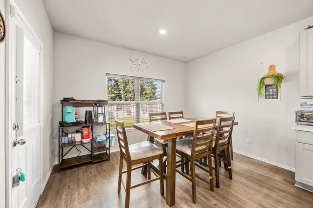 a view of a dining room with furniture and a window