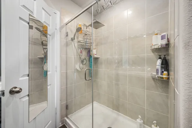 a bathroom with a shower and a sink