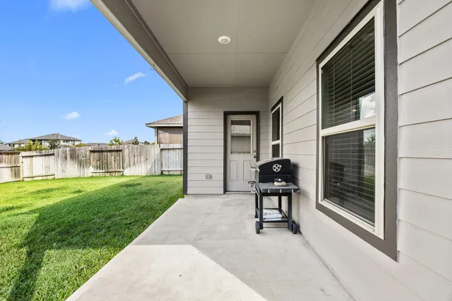 a view of backyard with seating space and deck