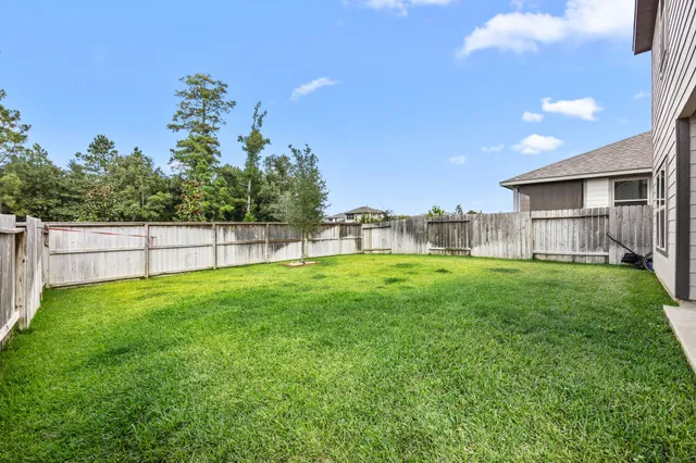 a view of a house with backyard and a porch