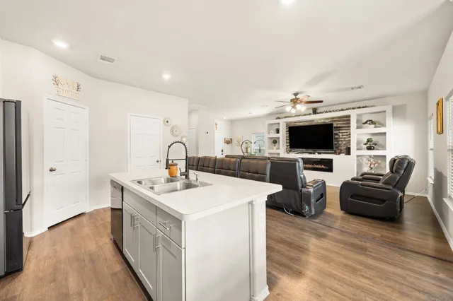 a kitchen with kitchen island a sink appliances and cabinets