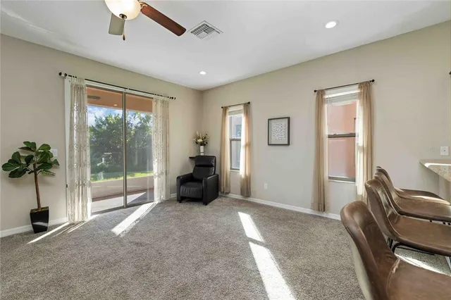 a living room with furniture and a floor to ceiling window