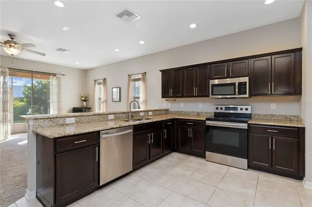 a kitchen with granite countertop stainless steel appliances and cabinets
