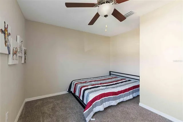 a bedroom with a bed and lamp