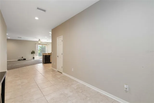 a view of a big room with closet and windows