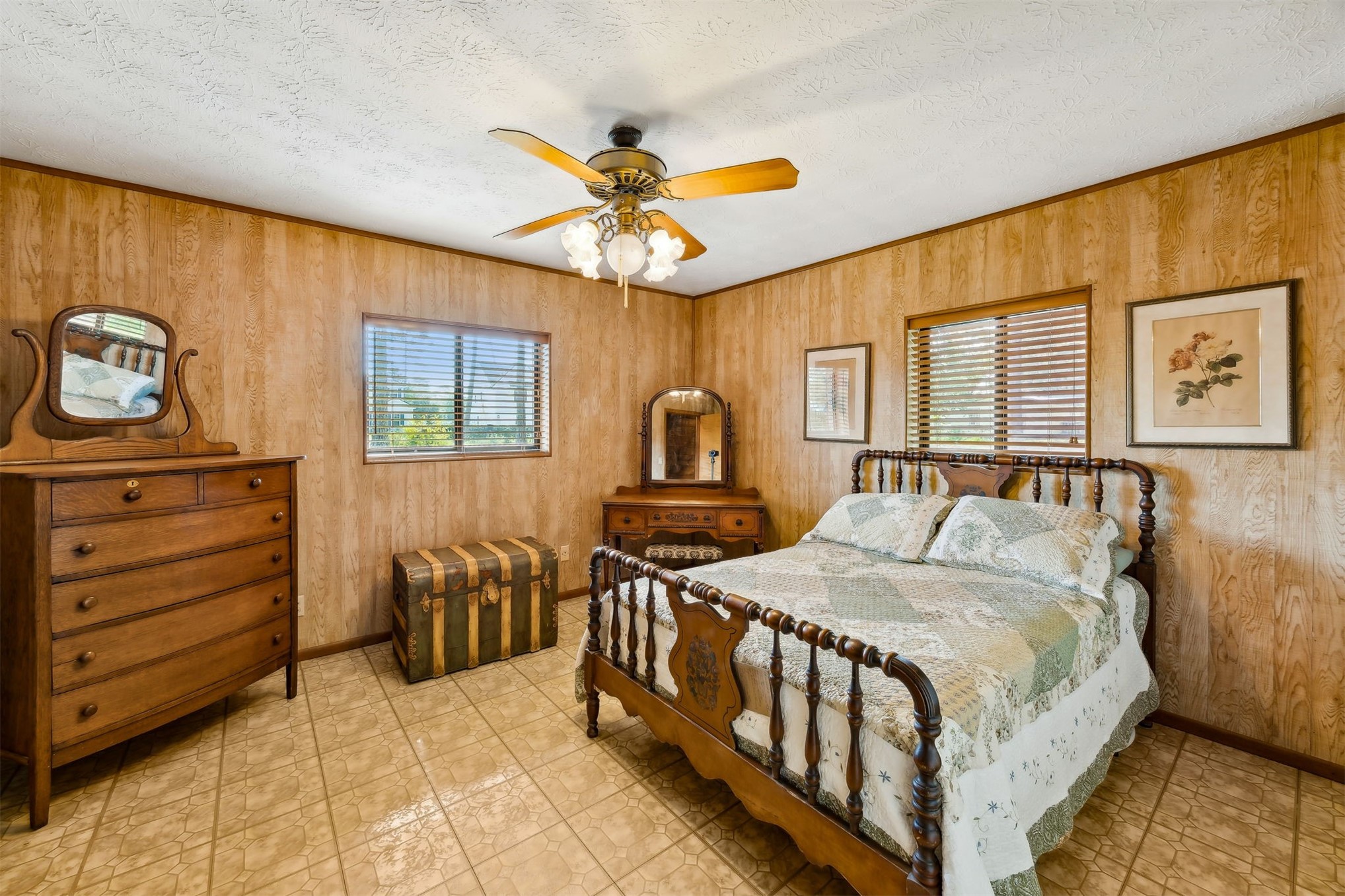 96111 Pirates Bluff Road Yulee, FL 32097 - Photo 20 of 52 a bedroom with a bed and a chandelier