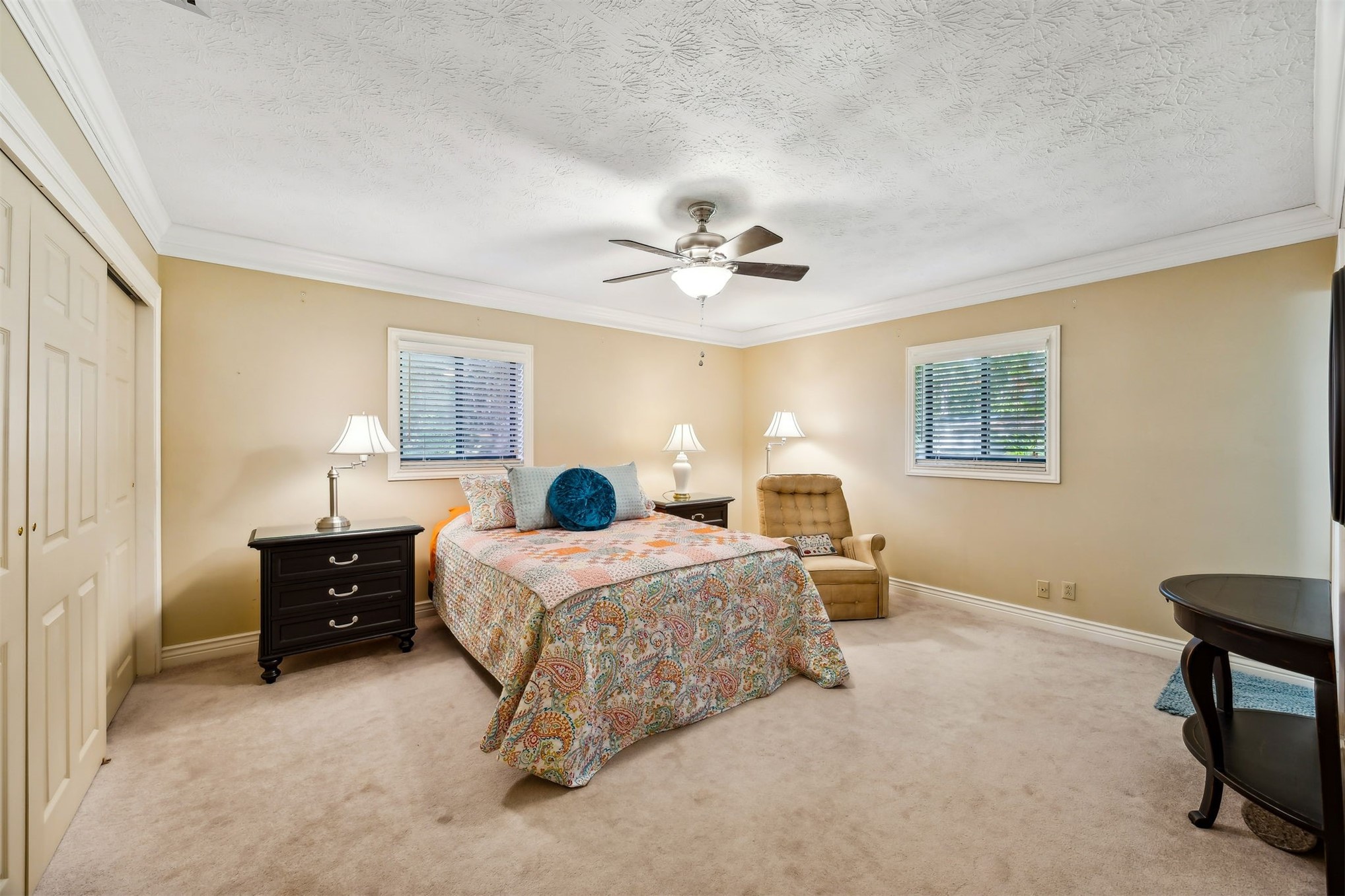 96111 Pirates Bluff Road Yulee, FL 32097 - Photo 23 of 52 a bedroom with a bed and a chandelier