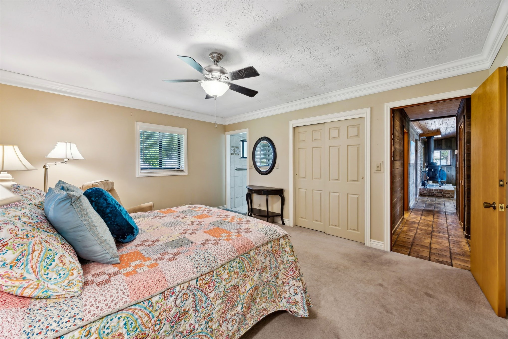 96111 Pirates Bluff Road Yulee, FL 32097 - Photo 27 of 52 a bedroom with a large bed and a chandelier
