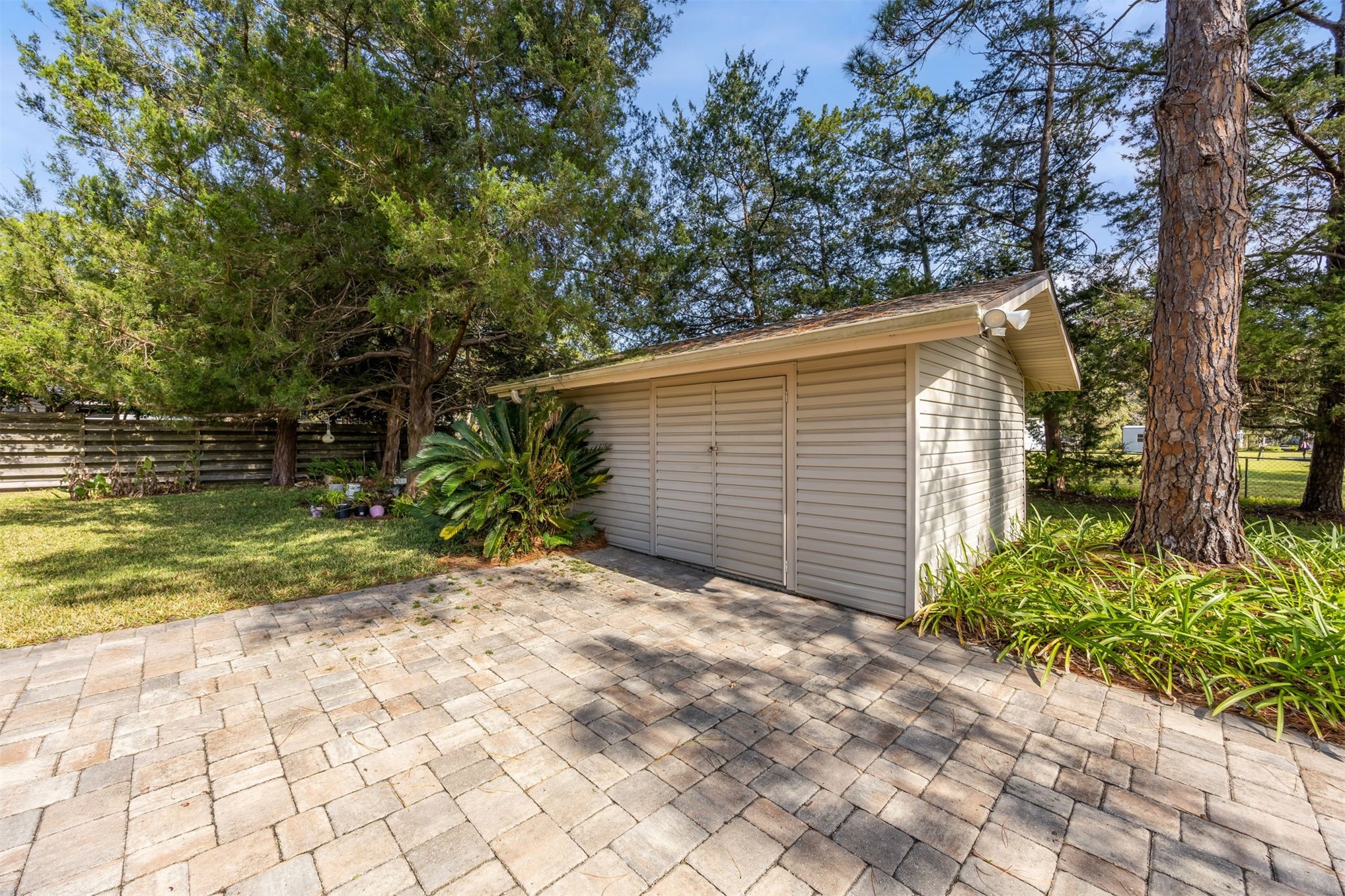 96111 Pirates Bluff Road Yulee, FL 32097 - Photo 40 of 52 a backyard of a house with lots of green space
