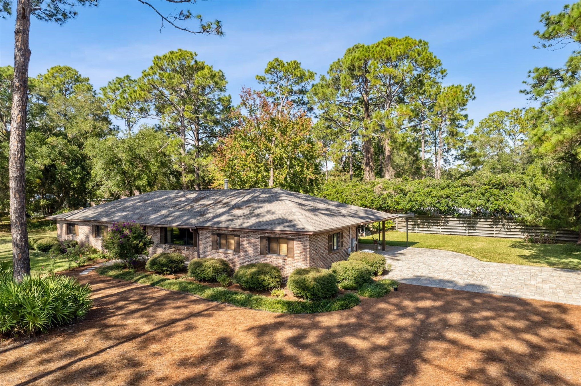96111 Pirates Bluff Road Yulee, FL 32097 - Photo 42 of 52 a view of a big house with a big yard and large trees