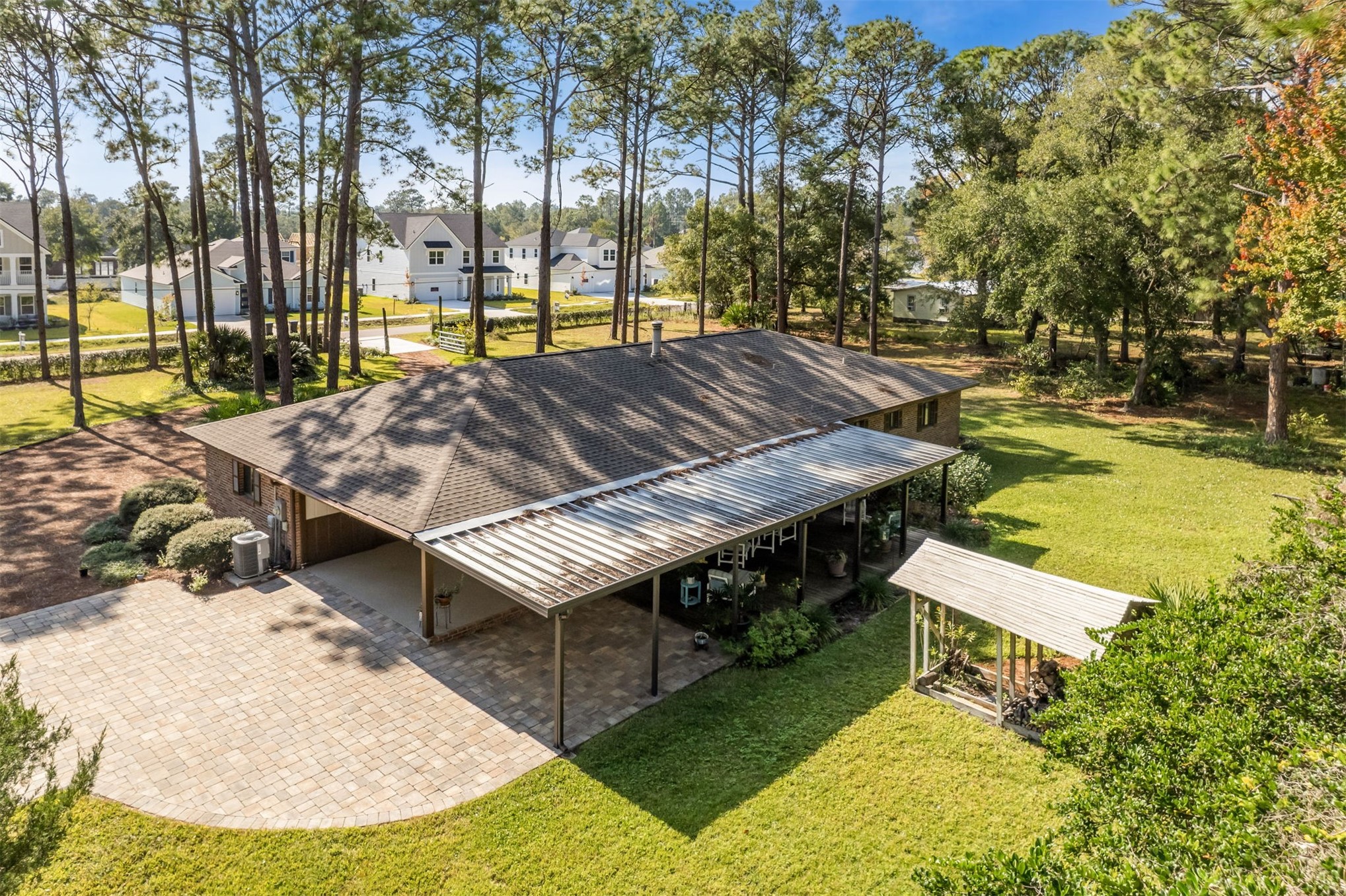96111 Pirates Bluff Road Yulee, FL 32097 - Photo 43 of 52 a view of a swimming pool with lawn chairs under an umbrella