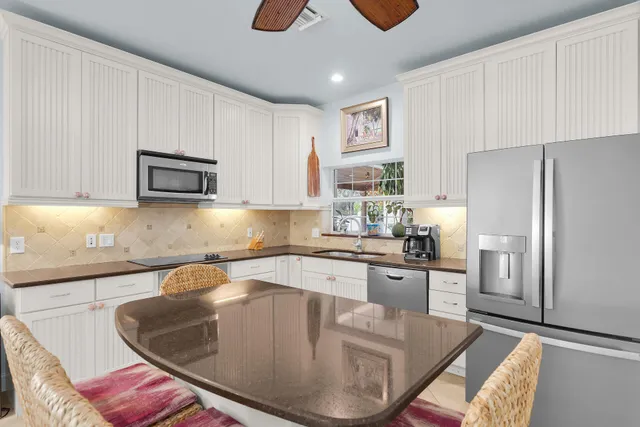 a living room with furniture two lamps and a large window