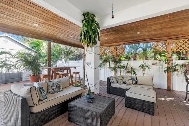 a view of a living room with furniture and a potted plant
