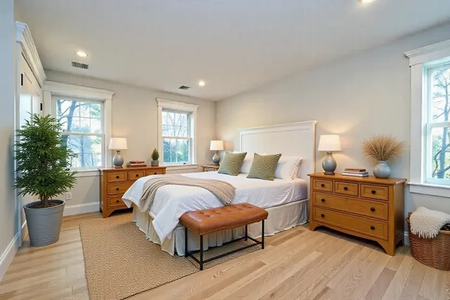 a spacious bedroom with a bed and window