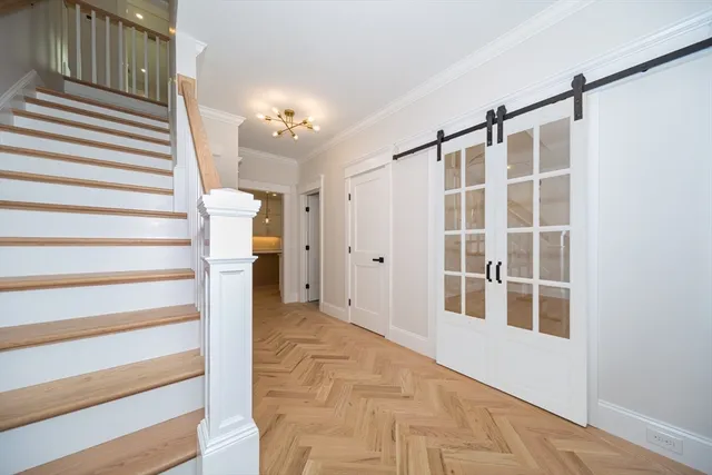 a view of entryway with wooden floor and windows