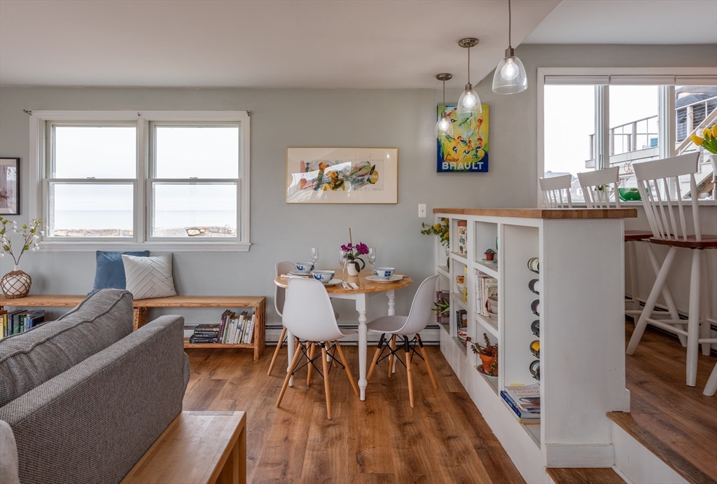 4 N Road, Unit 2 Rockport, MA 01966 - Photo 12 of 21 a view of a dining room with furniture a chandelier and wooden floor