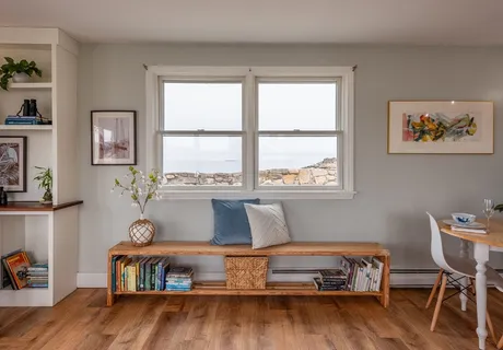 a living room with furniture and large windows