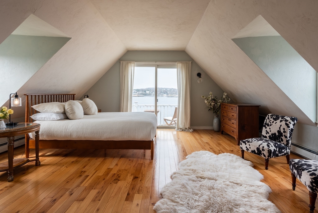4 N Road, Unit 2 Rockport, MA 01966 - Photo 16 of 21 a bedroom with furniture and wooden floor