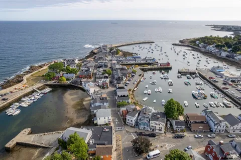 an aerial view of a houses with ocean view