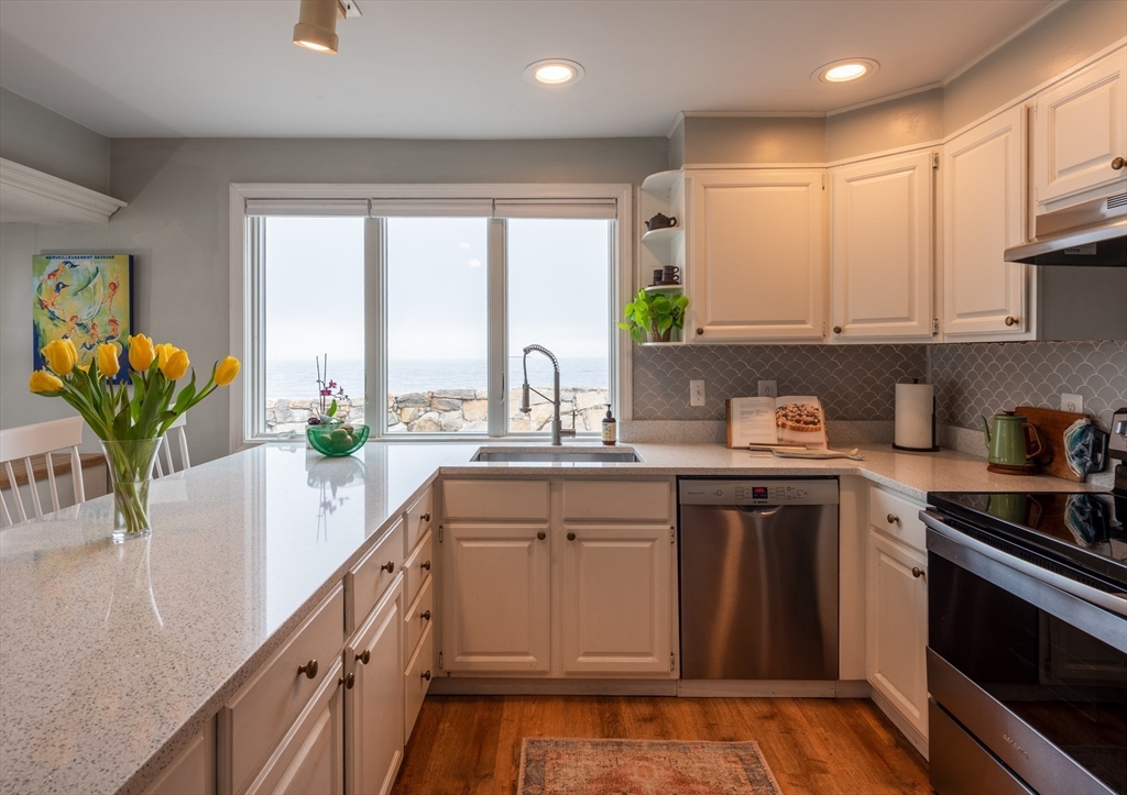 4 N Road, Unit 2 Rockport, MA 01966 - Photo 7 of 21 a kitchen with stainless steel appliances granite countertop a stove a sink and a white cabinets
