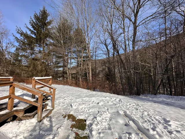 a backyard of a house with barbeque oven and outdoor seating