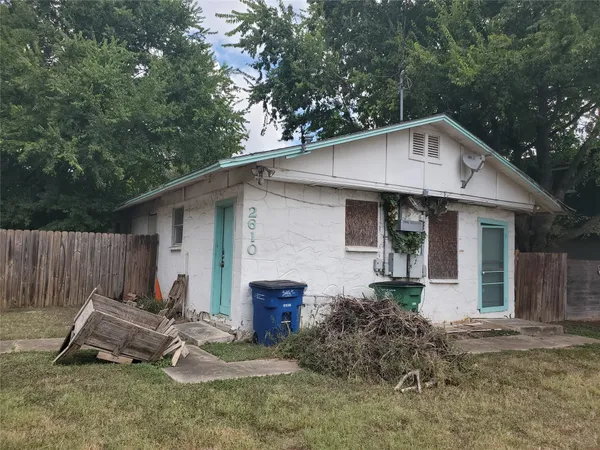 a backyard of a house with table and chairs