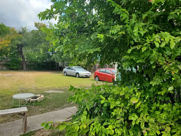 a front view of a house with a garden and parking space