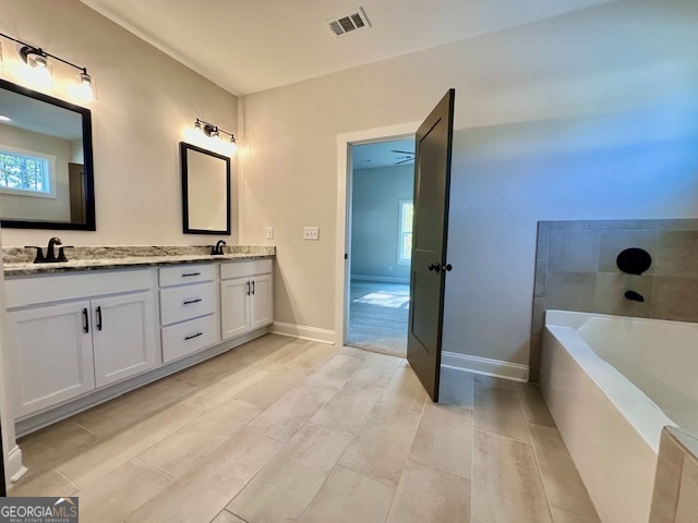 244 Deer Creek Run Moreland, GA 30259 - Photo 15 of 21 a spacious bathroom with a tub sink and mirror